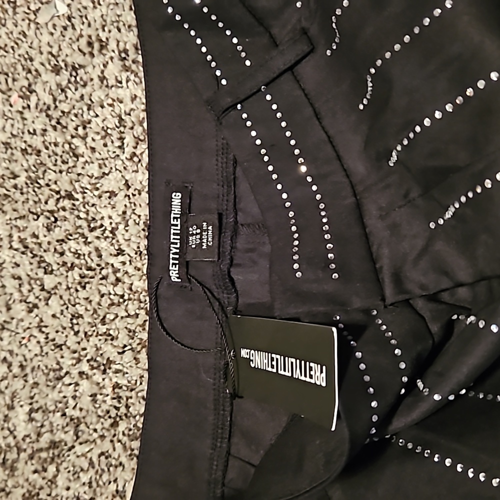size 12. Black pants. Great for going out. New with tag. Pretty little thing